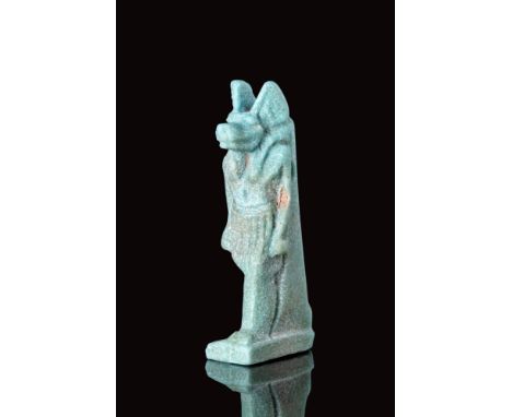 Late Period, Ca. 664 - 30 BC.An Egyptian amulet depicting the jackal-headed god Anubis, standing on a rectangular base. It ha