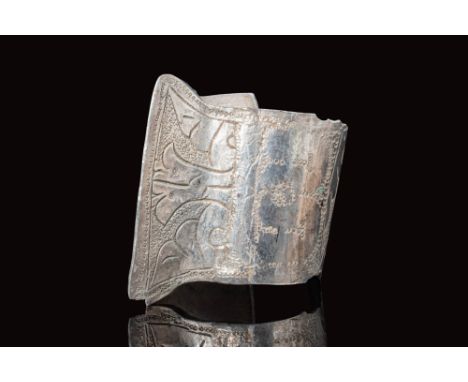 Ca. AD 1000 - 1200.A silver Seljuk penannular bracelet with a central ridge and two opposing decorated panels on the sides. E