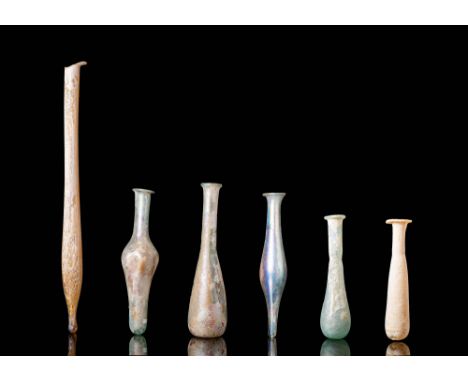 Ca. 300 - 100 BC.A delicate Hellenistic glass unguentarium, made from translucent, light brown-coloured glass. The bottle fea