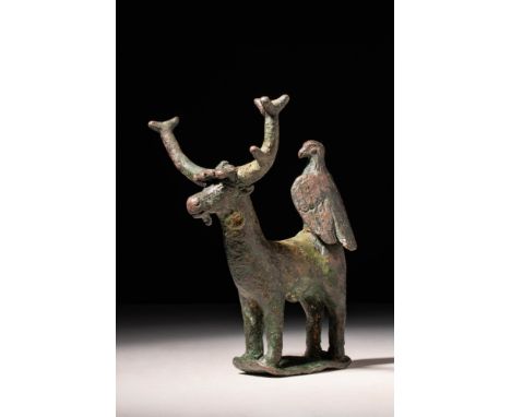 Ca. AD 100 - 300 .A cast-bronze stag depicted standing atop four sturdy legs. The animal has a slender, elongated body with n