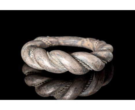 Ca. AD 900.A Viking twisted silver ring comprising of two threads that widen at the centre. The threads join at the bottom of