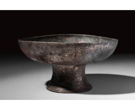 Ca. AD 200 - 600.A Sasanian silver goblet on a high round foot decorated with an engraved bird surrounded by geometric motifs