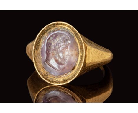 Ca. AD 300.A Roman gold ring depicting a nobleman facing right. The figure is made in a naturalistic manner, with short hair 
