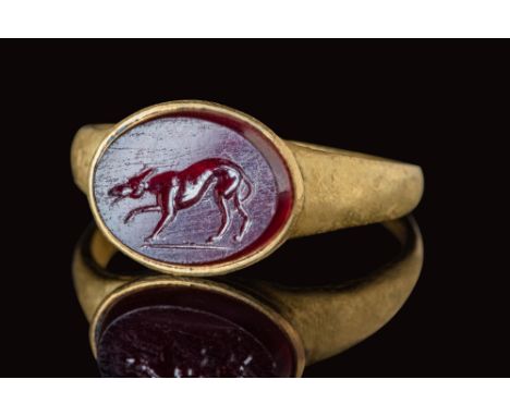 Ca. AD 100 - 300.A Roman solid gold ring with a round hoop, with a flat section that enlarges on the shoulders to form a roun