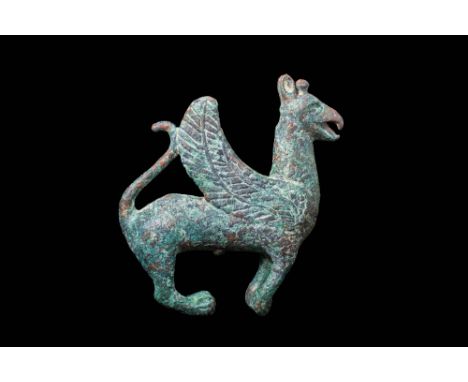Ca. 800 - 700 BC.A solid Assyrian cast-bronze standing griffon with a naturalistic body. The griffon is depicted with spread,