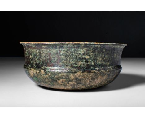 Ca. 500 - 300 BC.An Etruscan cast-bronze vessel with a carinated body, small discoid base and a large neck connected to a sho