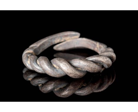 Ca. AD 800 - 1100.A Viking ring with twisted wires and a solid shank formed from silver. The top portion features four pairs 