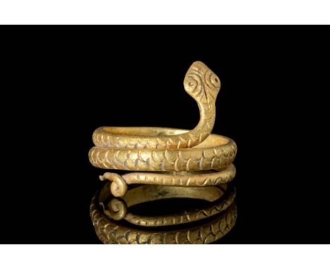 Ca. AD 50 - 200.An Egypto-Roman gold snake ring comprised of a long conical body adorned with incised scales, connected to a 