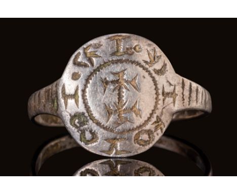Ca. AD 1000 - 1200.A crusader silver ring with a thin round hoop enlarged on the shoulder to form a circular bezel. The bezel