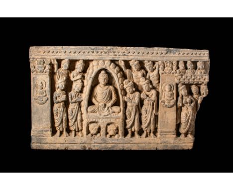 Ca. AD 100 - 200 .A stone panel depicting the scene of the Buddha's first sermon seven weeks after his Enlightenment. The pur