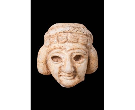 Ca. 2400 - 1800 BC.A sculpted head of a male worshipper with an intricate hairstyle, a long straight nose, almond-shaped eyes