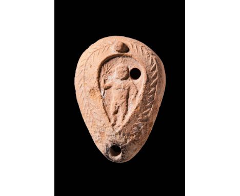 Ca. AD 400 - 500. A Levantine pottery oil lamp embellished with a depiction of Zeus. He is depicted naked and holding lightni