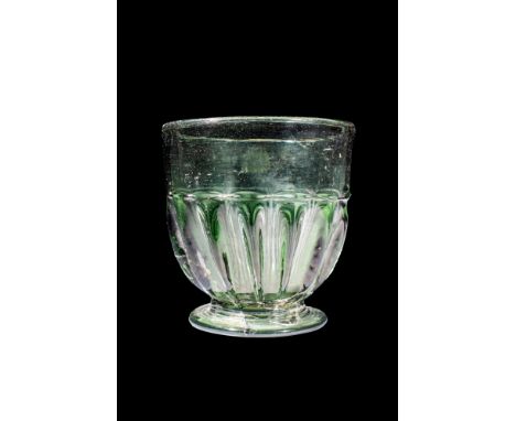 Ca. AD 1400 - 1600. A late Medieval German glass beaker, with a vertical neck leading from a cylindrical, ribbed body connect
