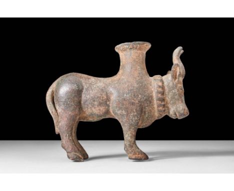 Ca. 1200 - 800 BC.A cast-bronze Western Asiatic stand of a bull standing on four legs. The powerful bovine creature holds its