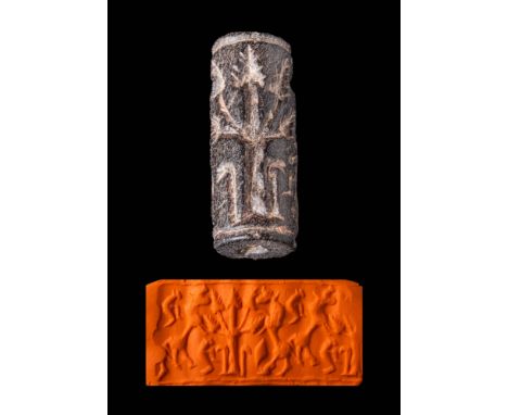Ca. 1100 - 900 BC.A Elamite Bitumen cylinder seal. The design shows a sacred tree, with a rearing bovine on each side. The tr