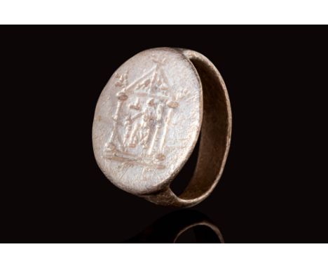 Ca. AD 100 - 300.A Roman silver ring with a circular bezel depicting the facade of a temple. The temple is engraved with arch