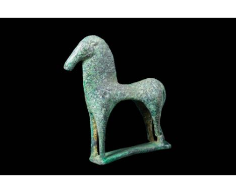 Ca. 800 - 700 BC.A fabulous Greek cast-bronze horse figurine in a stylised form. The tubular animal widens slightly at the hi