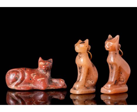 Late Period, Ca. 664 BC - AD 100.A collection of three Egyptian stone amulets of the goddess Bastet. The first amulet on the 