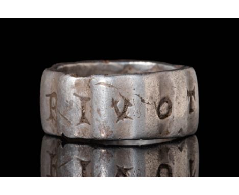 Ca. AD 100 - 300.A Roman silver ring with a polygonal stepped hoop decorated with niello inlaid Latin letters between the ste