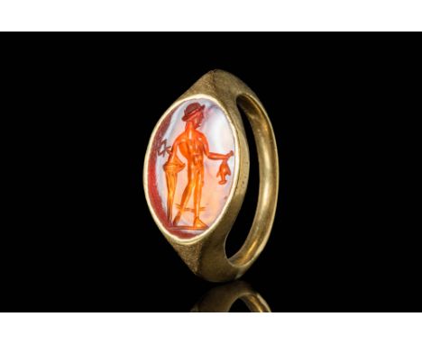 Ca. AD 200 - 300. A Roman gold ring with a carnelian intaglio depicting the god Mercury. The god is carved in a stylised mann