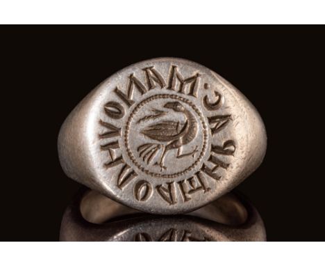 Ca. AD 1000 - 1200.A Crusaders silver ring with a round D-section hoop enlarged on the shoulders to form a circular flat beze
