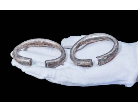 Ca. 300 - 100 BC. A pair of matching Celtic silver hollow bracelets, with a tubular hoop that widens at the centre. The brace