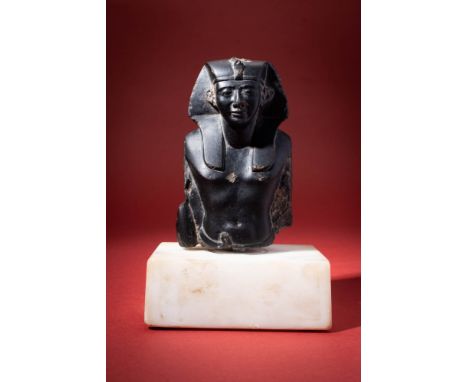 Late Period, Ca. 664 - 332 BC. A rare black stone statue of a Pharaoh. His bare upper body exhibits a slender waist and stron