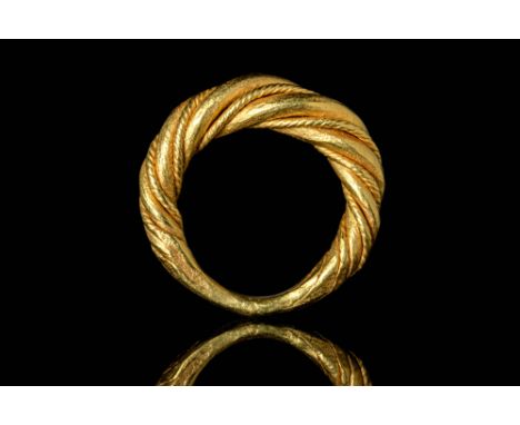Ca. AD 900.A Viking twisted 20ct gold ring comprises of two gold threads widening in the centre. The threads join and become 