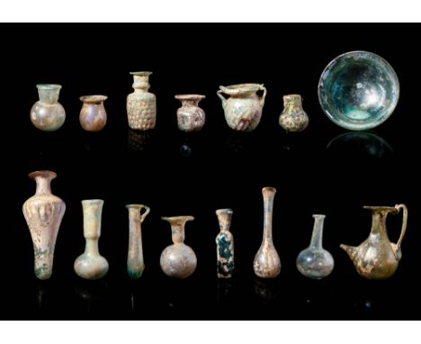 Ca. AD 100 - 400.A large collection of roman glass vessels consisting of unguentaria, bowls and jugs with differing shapes an