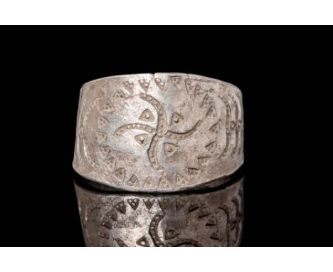 Ca. AD 800 - 1100.A Silver Viking ring shaped from a hammered sheet of silver with a flat hoop. The front face of the ring is