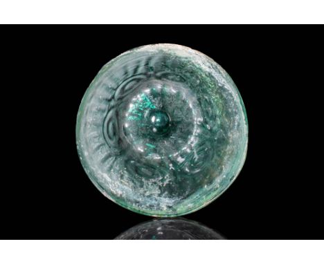 Ca. AD 50 - 100. A Roman green glass bowl with moulded decorations. The bowl is beautifully preserved, made of translucent gl