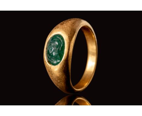 Ca. AD 100 - 200.A Roman solid gold ring with a round D-section hoop which widens on the shoulders to form an oval bezel. The