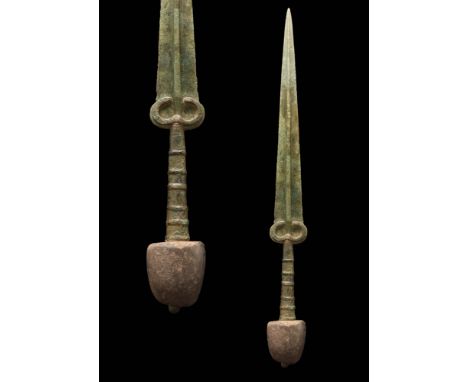 Ca. 1200 - 800 BC.A Western Asiatic/ Aegean bronze sword with a long, tapering blade, a prominent mid-rib and a gracefully cu