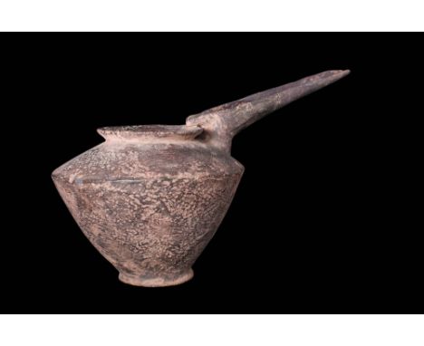 Ca. 1200 - 800 BC.A large Amlash grey ware terracotta vessel with a long-spout. It is composed of a carinated body on a disco