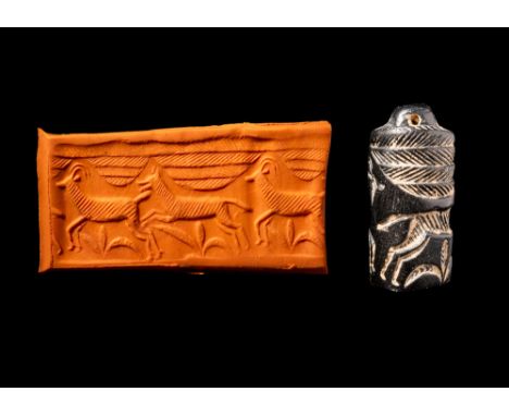 Ca. 1800 - 1400 BC. A Central Asian shiny black stone cylinder seal, with a pierced loop for suspension. On the base of the c