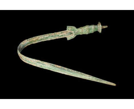 Ca. 1200 - 600 BC. A European bronze sword with a long tapering blade, a prominent large polygonal mid-rib and a gracefully c