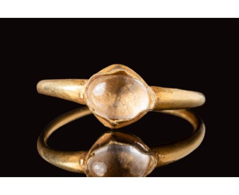 Ca. AD 700 - 900.A Saxon gold ring with a round bezel, securing a rock crystal cabochon.Size: D:16.1mm / US: 5 1/2 / UK: K 1/
