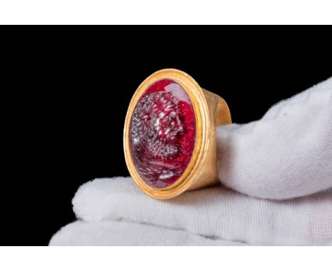 Ca. AD 100 - 200. A Roman gold ring depicting Caracalla. The ring has a round hoop enlarging on the shoulders to form a round