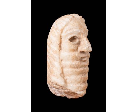 Ca. 2400 - 1800 BC.A sculpted head of a male worshipper with a long, stepped beard. The worshipper has a long, straight nose,
