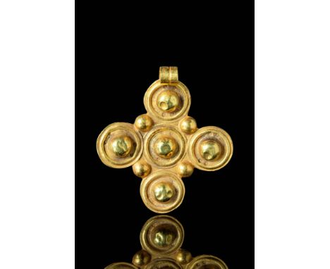Ca. AD 700 - 1000.A Byzantine gold cross-shaped pendant decorated with five moulded circles, to represent the five wounds of 