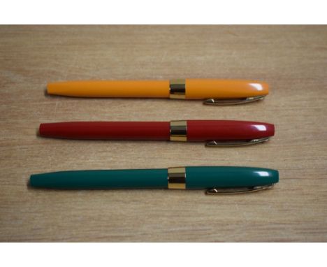 Three Sheaffer Imperial Rollerball pens in Orange, Red, and Green