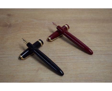 Two Parker Duofold Demi aerometric fill fountain pens one Burgundy one black both with Duofold broad cap band. Black having P