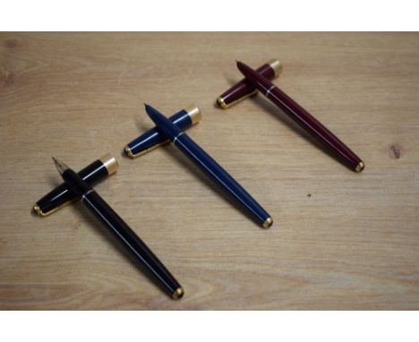 Three Parker 17 Super Duofold aerometric fill fountain pen in blue, black and red with gold trim
