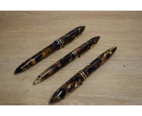 A Sheaffer Balance II cartridge/converter fountain pen, Ballpoint pen and Rollerball pen in Amber Glow with two gold rings to