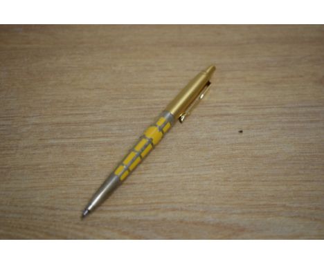 A Parker Jotter 50th Anniversary edition ballpoint pen in saffron yellow with silver filigree and gold cap
