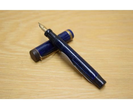 A Parker Duofold Junior Lucky Curve button fill fountain pen in dark Lapis Lazulii with a broad gold band to the cap (rubbed)