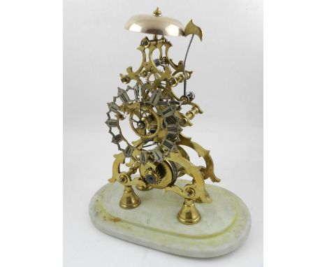 A brass skeleton clock, having single chain fusee movement, the pierced and shaped silvered chapter ring with Roman numerals,