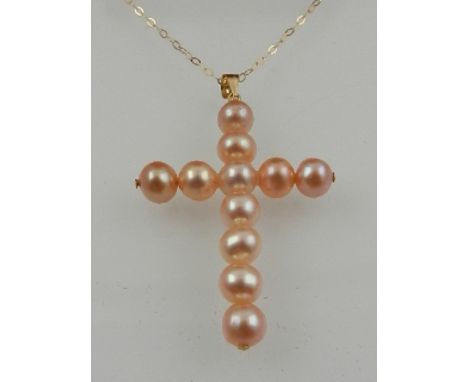 A yellow metal mounted pearl cross pendant, suspended on a 9 carat yellow gold chain. 