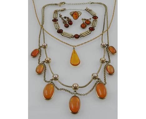 A 9 carat yellow gold link bracelet, set with oval cabuchon amber stones, together with a 9 carat yellow gold and amber ring,