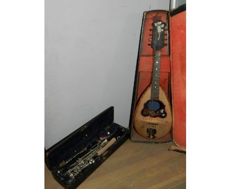 A late 19th century French three section clarinet, cased together with a cased Italian mandolin.